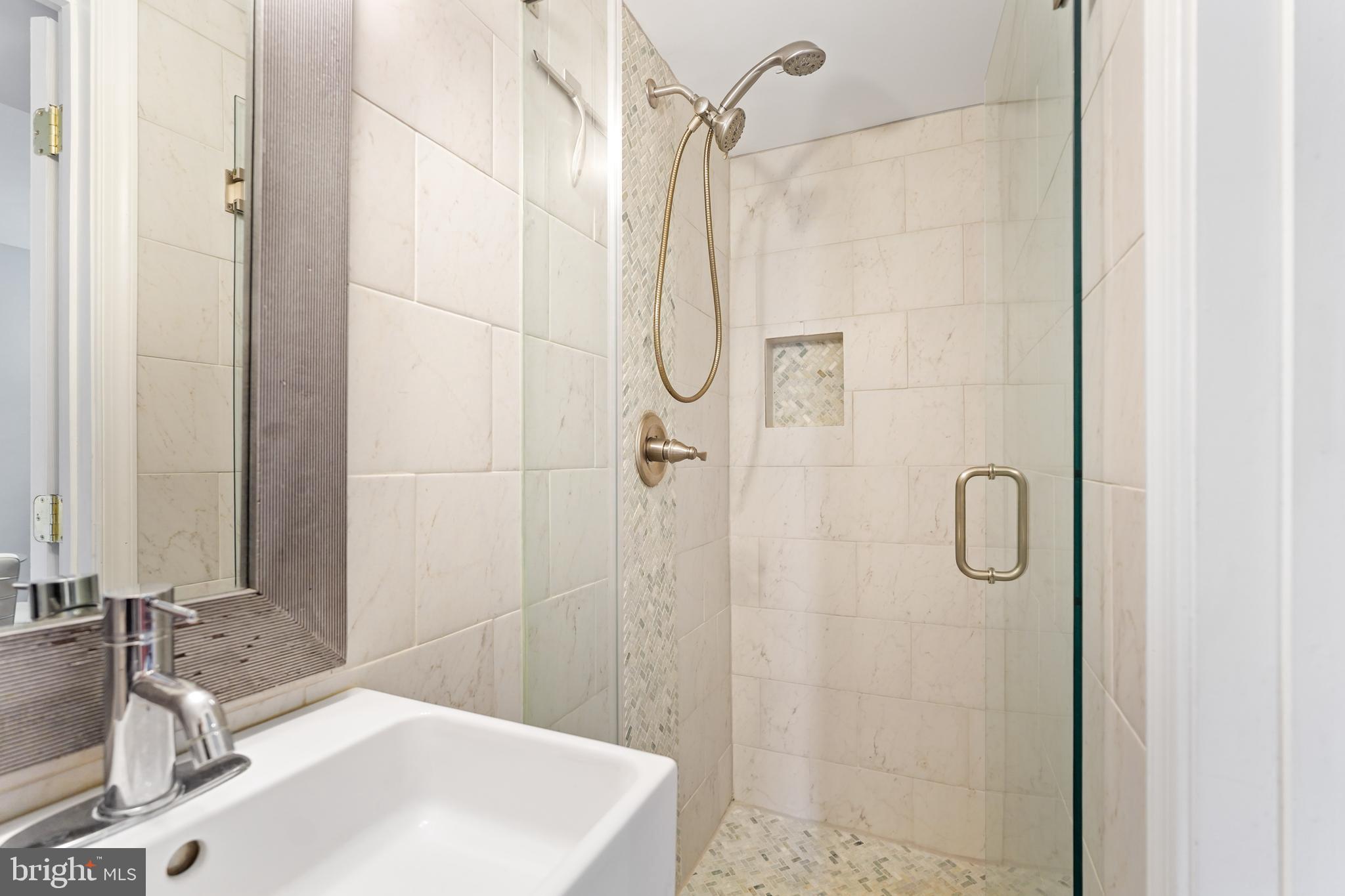44 Dale Street Alexandria, VA 22305 - Photo 31 of 40 a bathroom with a granite countertop shower sink and vanity