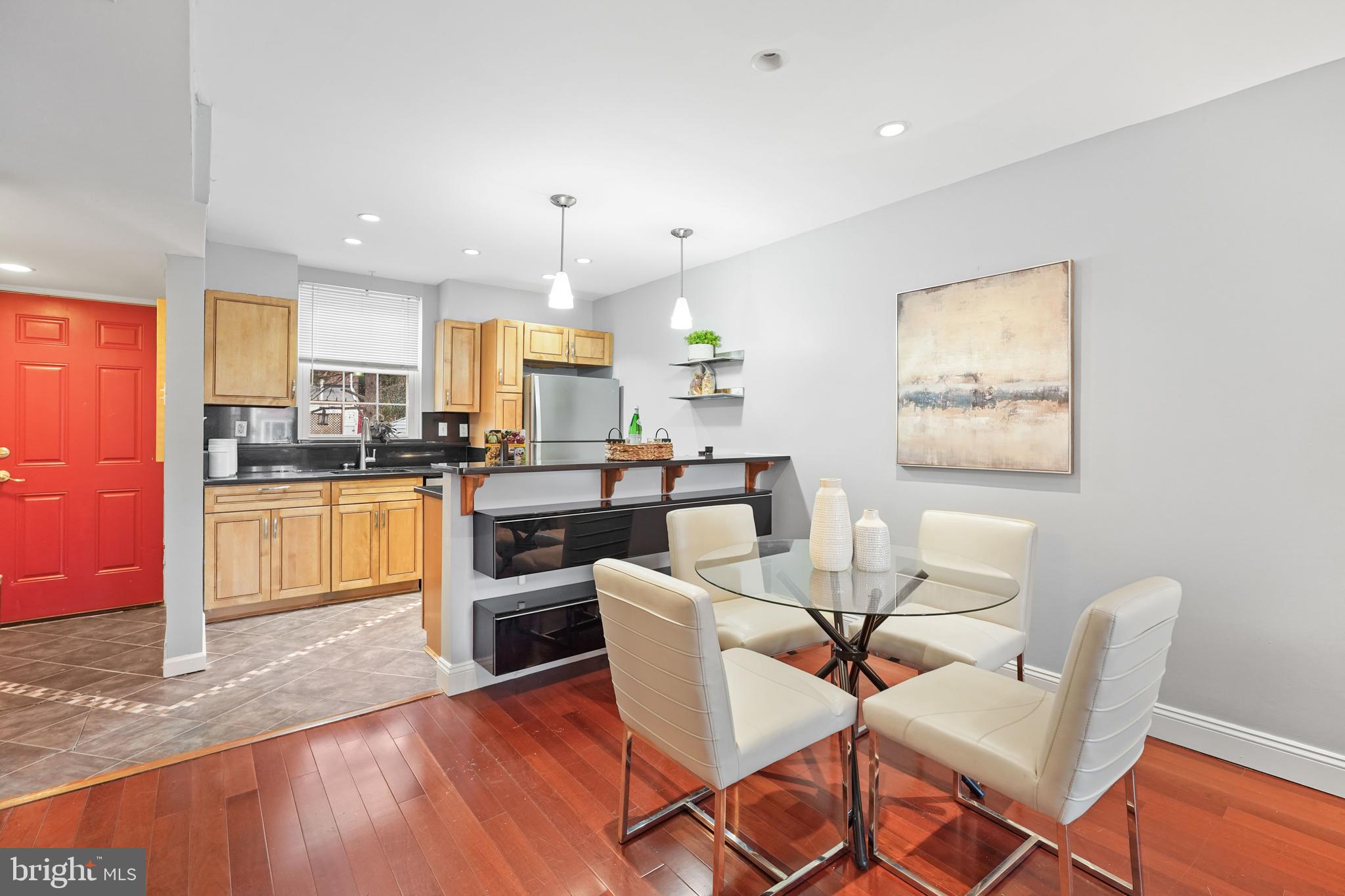 44 Dale Street Alexandria, VA 22305 - Photo 32 of 40 a kitchen with stainless steel appliances kitchen island granite countertop wooden floors and white cabinets