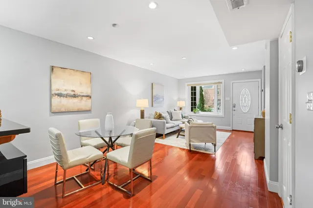 a living room with fireplace furniture and a wooden floor