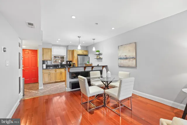 a living room with dining room and wooden floor