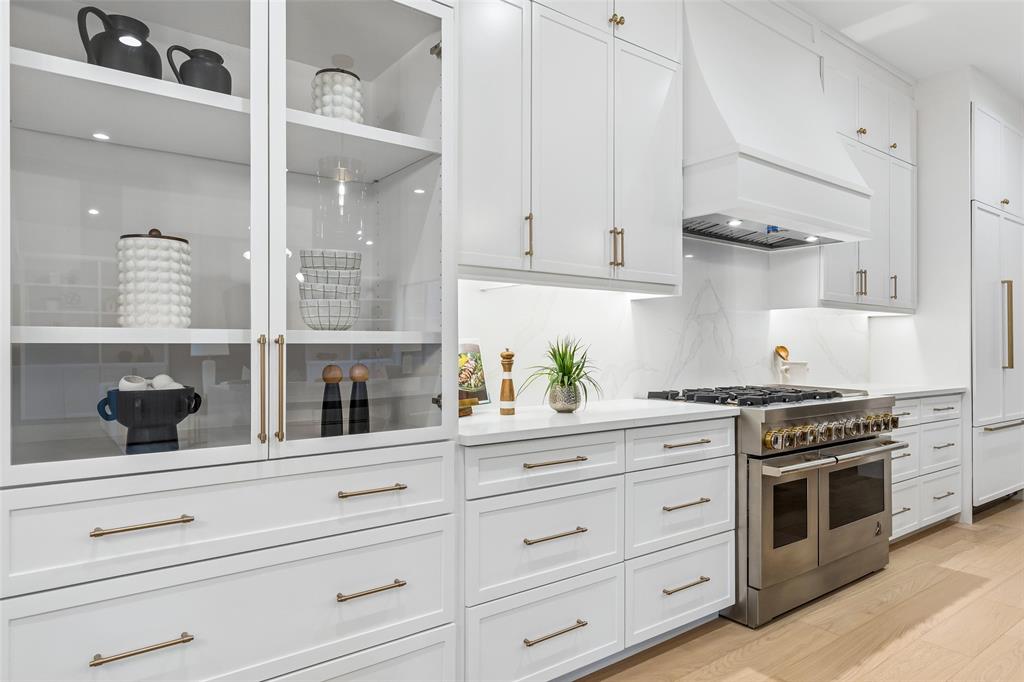 4311 Merrell Road Dallas, TX 75229 - Photo 12 of 30 a kitchen with white cabinets and appliances