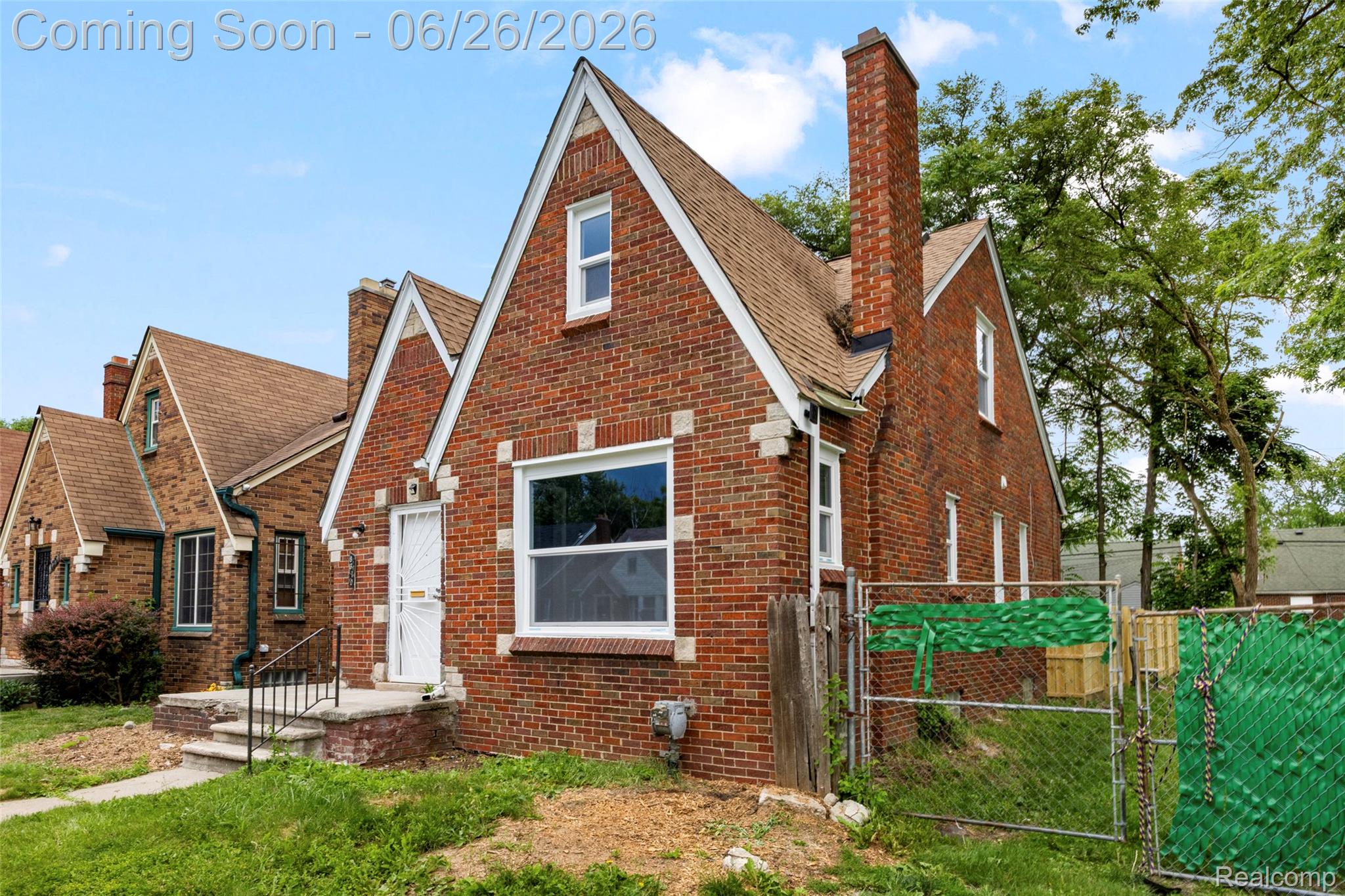 8310 Whitcomb Detroit, MI 48228 - Photo 4 of 26 Brick exterior with white trim detailing and a peaked roofline