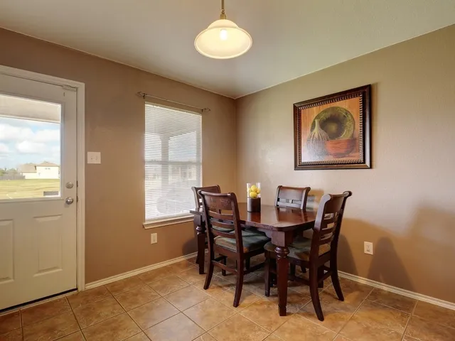 a view of a dining room with furniture and window