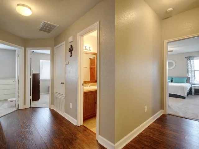 a view of a hallway with wooden floor