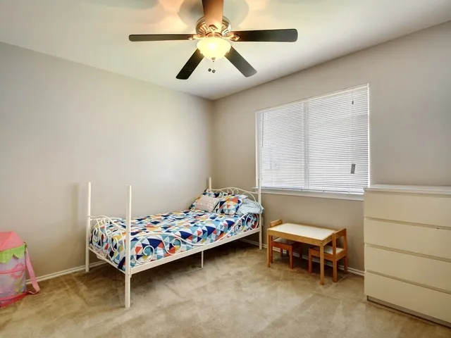 a bedroom with bed and a chandelier