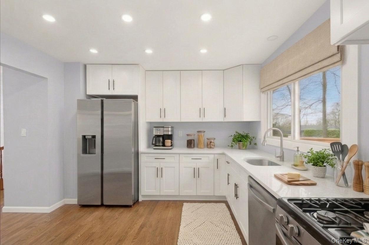 7 Gene Road Middletown, NY 10941 - Photo 11 of 43 Kitchen with stainless steel appliances, white cabinetry, recessed lighting, light wood-type flooring, and light stone countertops