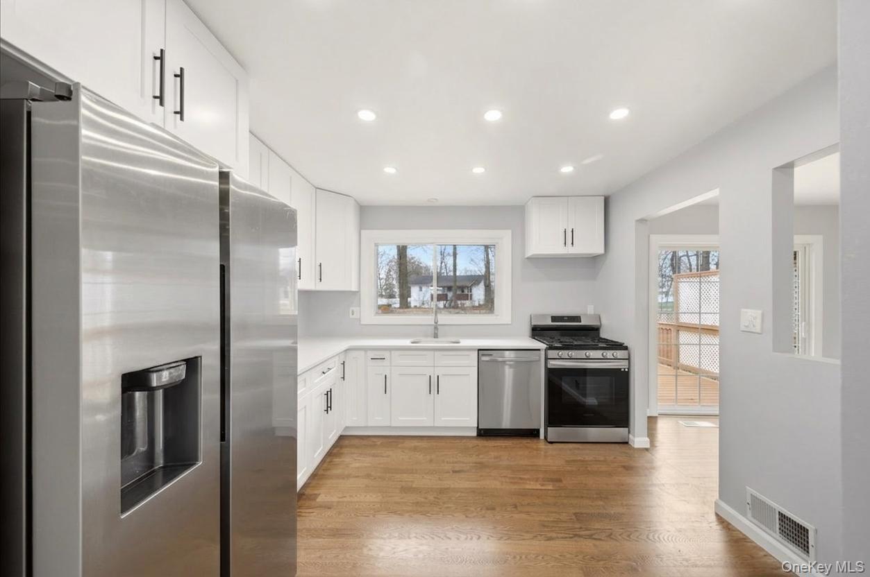 7 Gene Road Middletown, NY 10941 - Photo 13 of 43 Kitchen featuring stainless steel appliances, white cabinetry, light wood-style floors, plenty of natural light, and recessed lighting