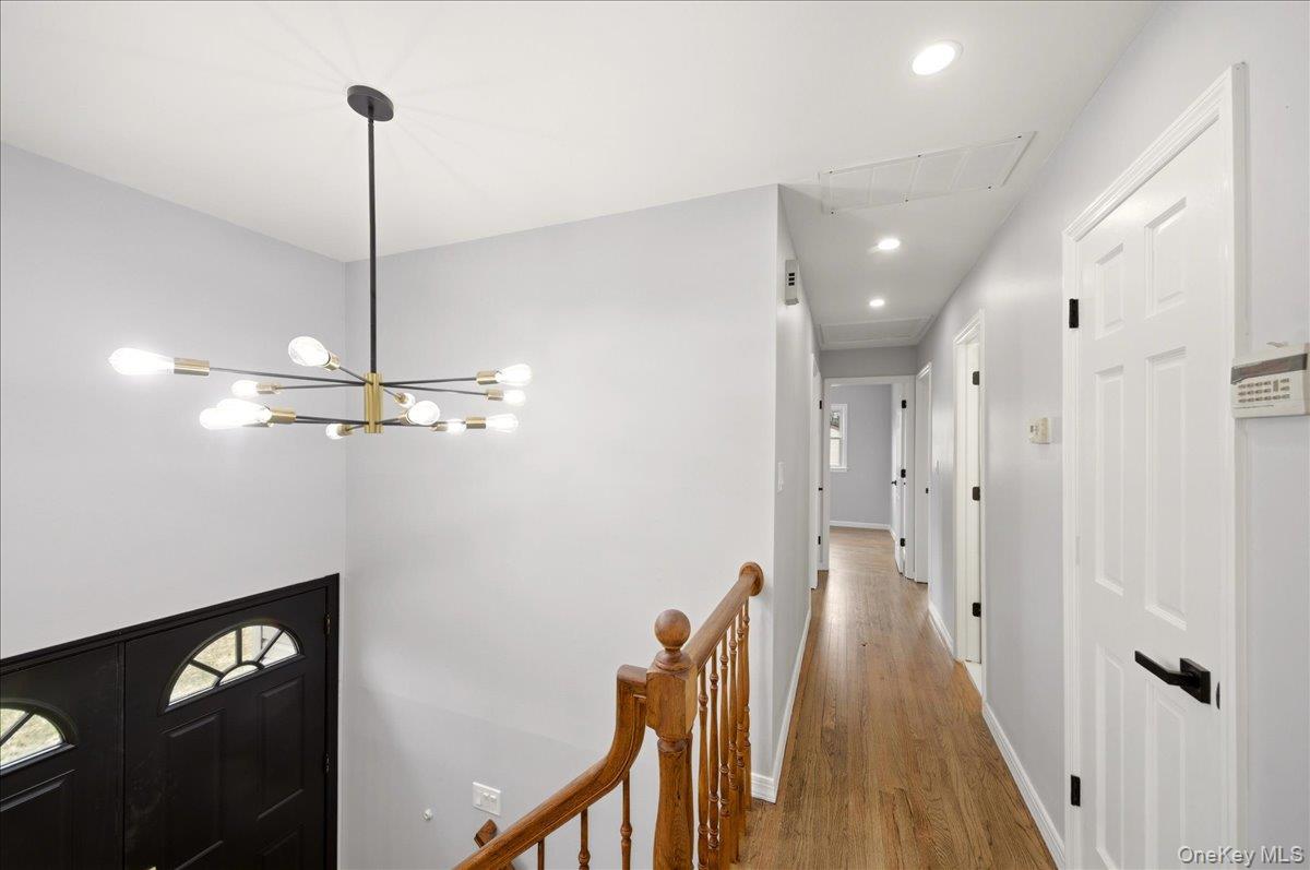 7 Gene Road Middletown, NY 10941 - Photo 14 of 43 Hallway with a chandelier, wood finished floors, and an upstairs landing