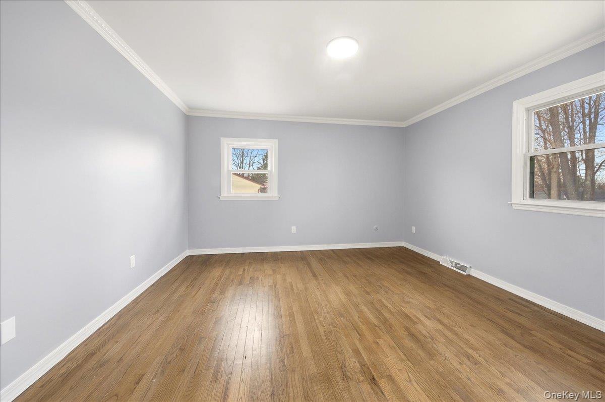 7 Gene Road Middletown, NY 10941 - Photo 15 of 43 Unfurnished room featuring dark wood-type flooring and crown molding