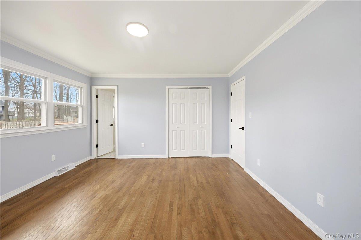 7 Gene Road Middletown, NY 10941 - Photo 17 of 43 Unfurnished bedroom featuring hardwood / wood-style floors, ornamental molding, and a closet