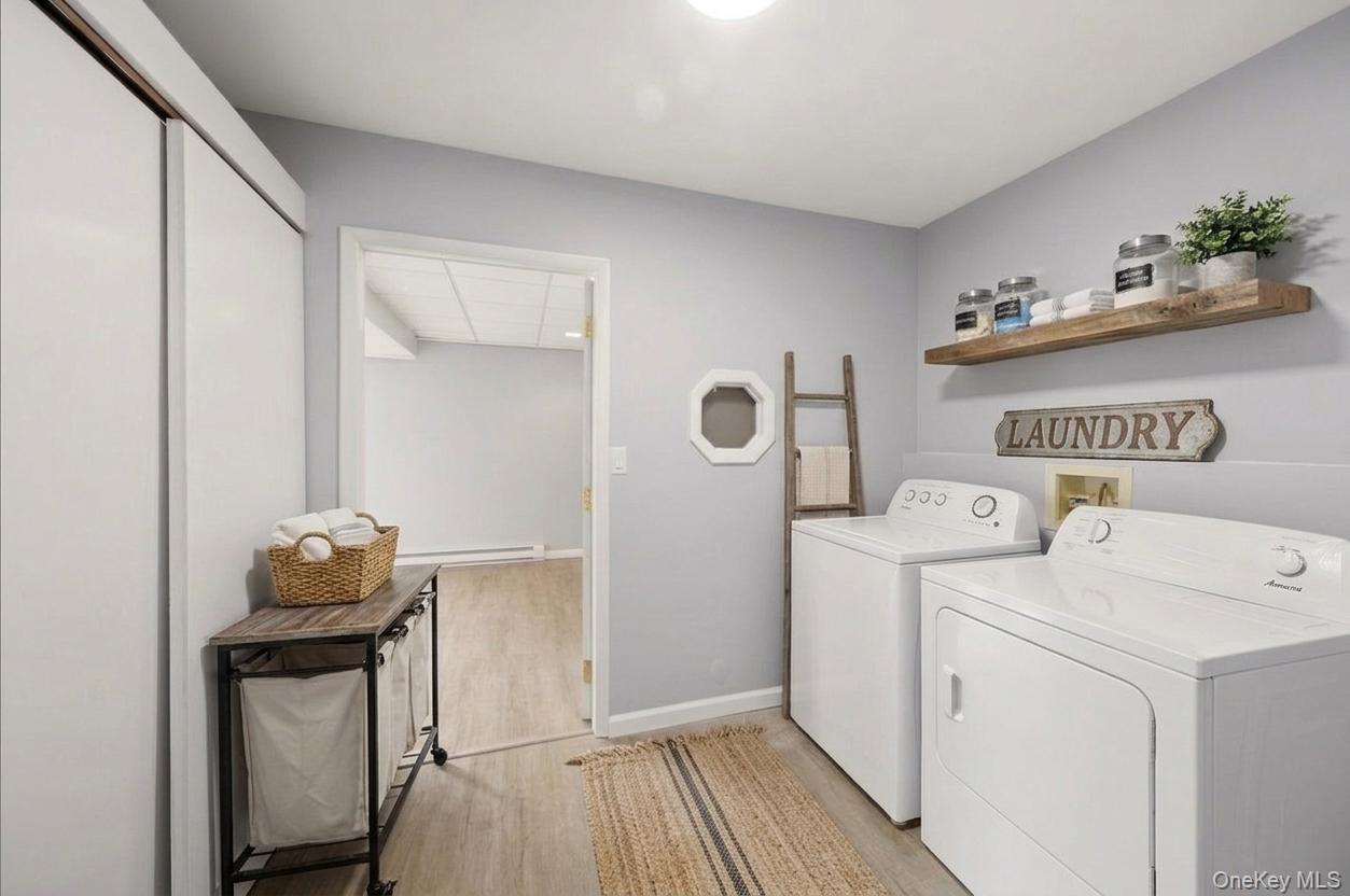 7 Gene Road Middletown, NY 10941 - Photo 29 of 43 Laundry room with washer and clothes dryer, light wood-type flooring, and baseboard heating