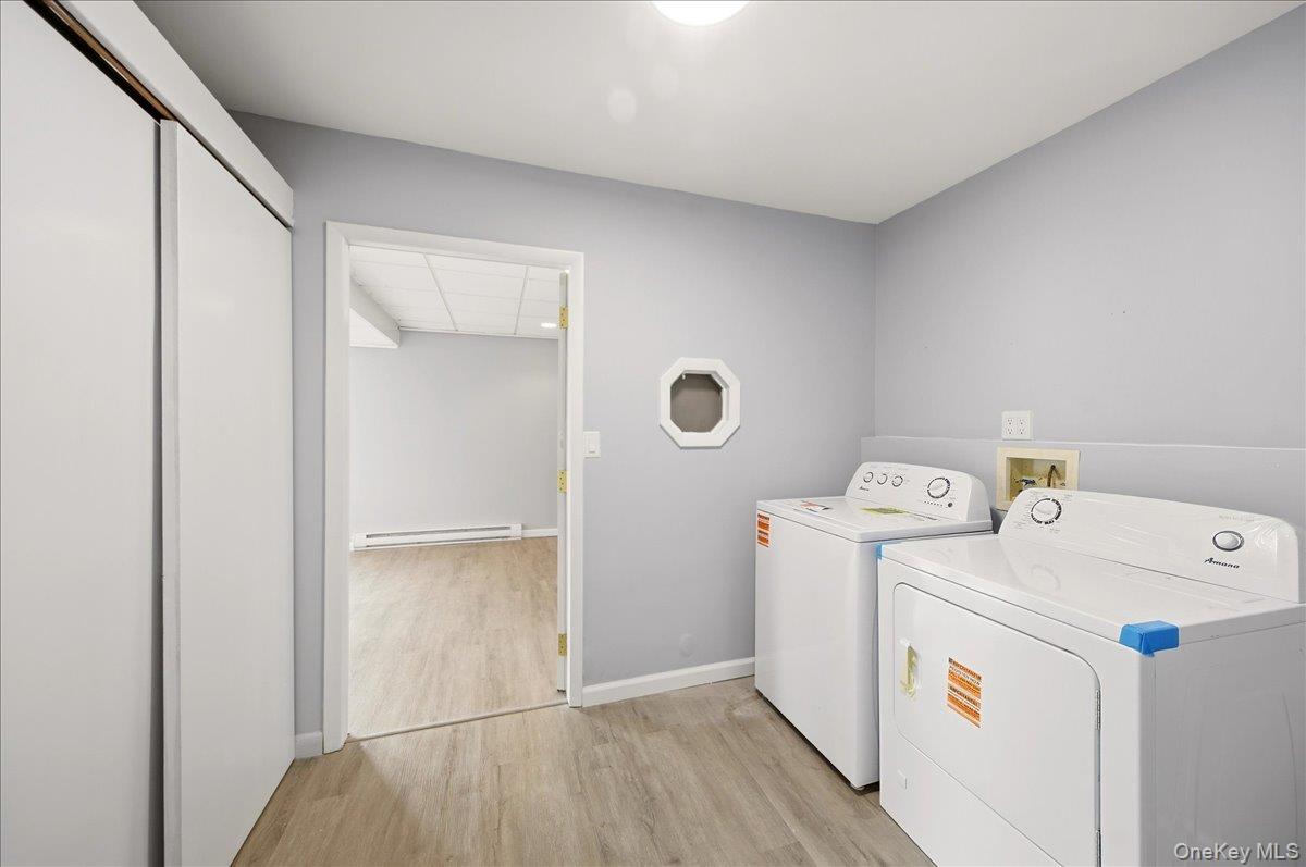 7 Gene Road Middletown, NY 10941 - Photo 30 of 43 Laundry area featuring light wood finished floors, washing machine and dryer, and baseboard heating