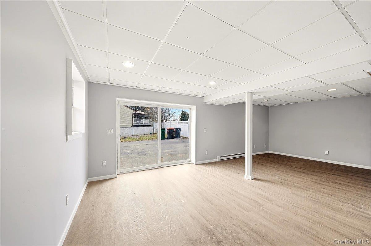 7 Gene Road Middletown, NY 10941 - Photo 31 of 43 Below grade area with light wood-type flooring, a drop ceiling, baseboard heating, and recessed lighting