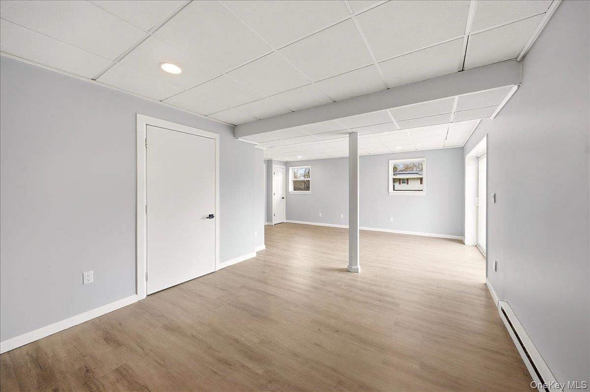 7 Gene Road Middletown, NY 10941 - Photo 32 of 43 Below grade area featuring a baseboard heating unit, a drop ceiling, light wood-type flooring, and recessed lighting