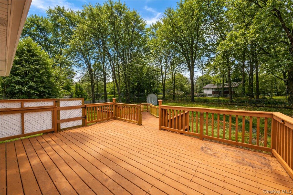 7 Gene Road Middletown, NY 10941 - Photo 34 of 43 Wooden deck featuring a storage unit and view of scattered trees
