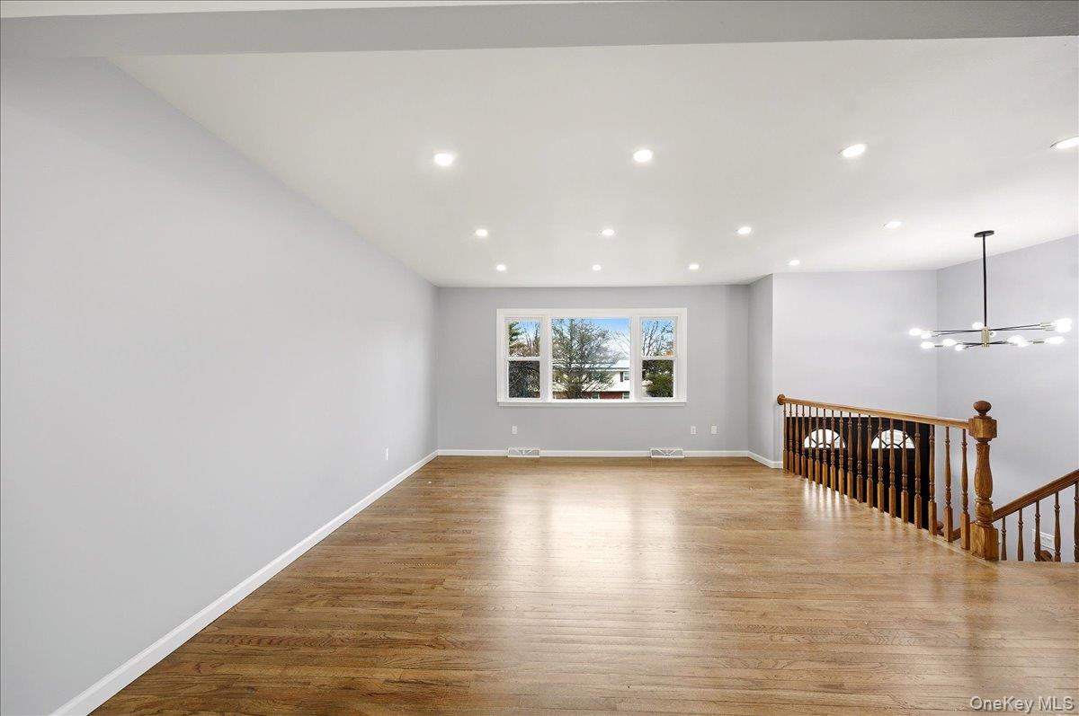 7 Gene Road Middletown, NY 10941 - Photo 8 of 43 Empty room with dark wood-style floors and suspended lighting