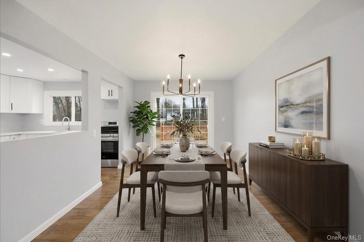 7 Gene Road Middletown, NY 10941 - Photo 9 of 43 Dining room with dark wood finished floors, a chandelier, and healthy amount of natural light