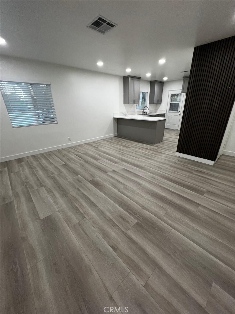 7442 Potomac Street Riverside, CA 92504 - Photo 2 of 8 a view of kitchen and empty room with wooden floor