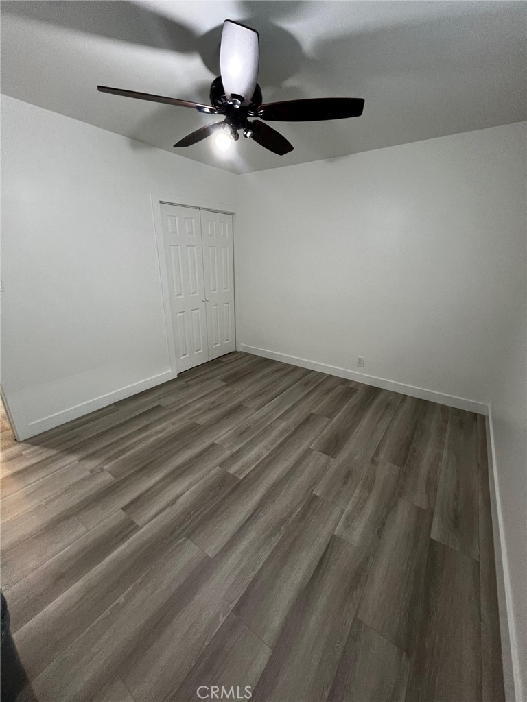 7442 Potomac Street Riverside, CA 92504 - Photo 7 of 8 a view of room with a ceiling fan and hardwood floor