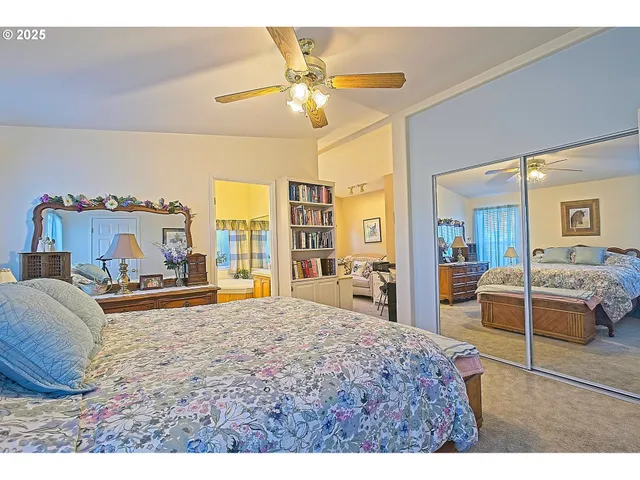 a bedroom with a large bed and a chandelier