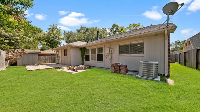 a backyard of a house with table and chairs