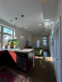 a kitchen with sink refrigerator and furniture