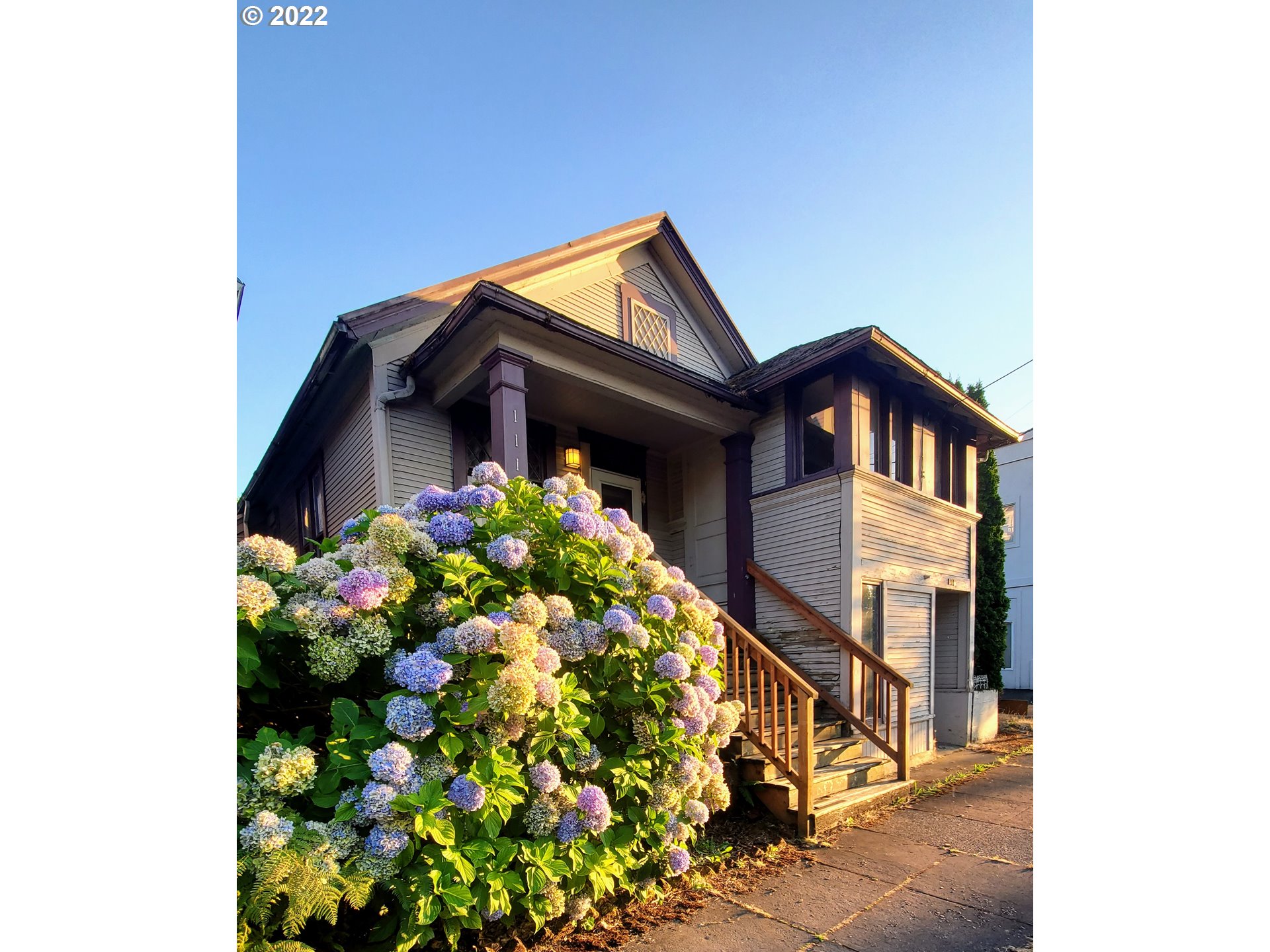 1116 Southeast Stephens Street Portland, OR 97214 - Photo 2 of 10 a front view of house with flowers