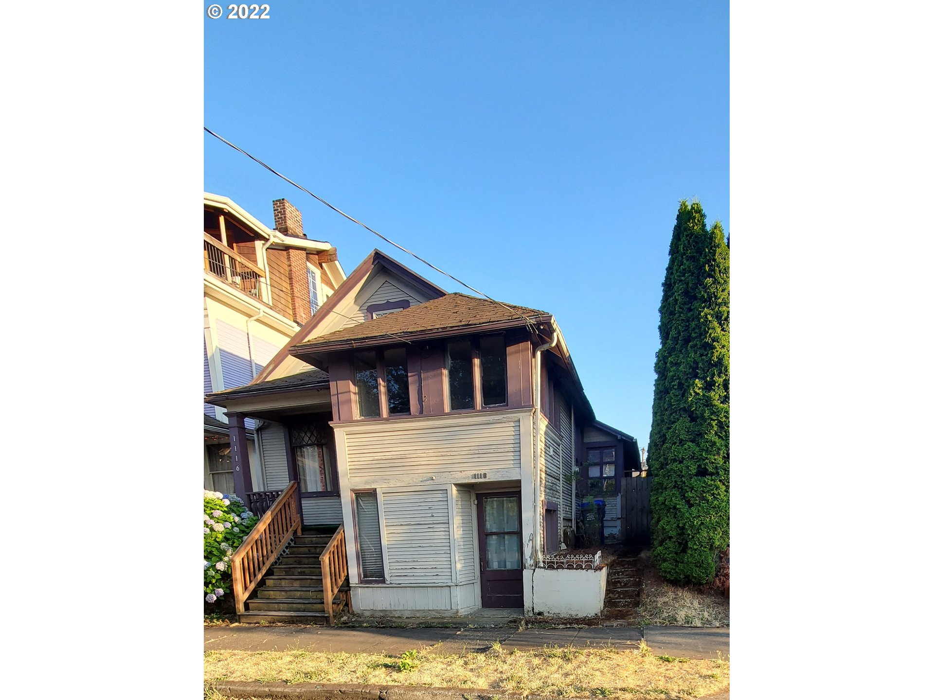 1116 Southeast Stephens Street Portland, OR 97214 - Photo 3 of 10 a view of a house with a small yard and large tree