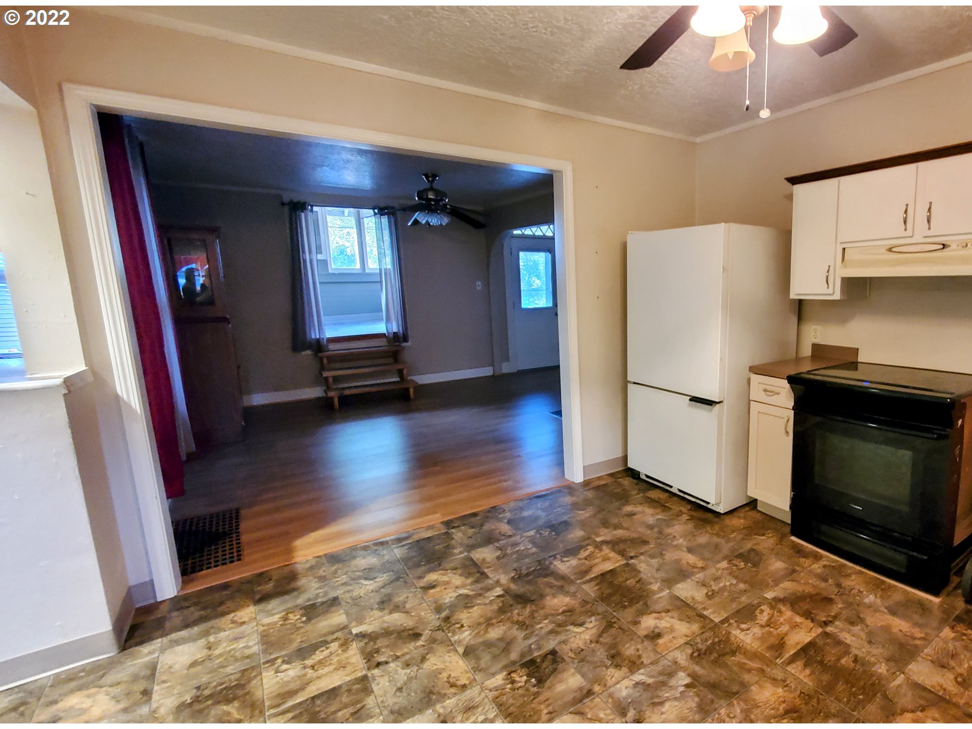 1116 Southeast Stephens Street Portland, OR 97214 - Photo 8 of 10 a view of empty room with a fireplace and wooden floor
