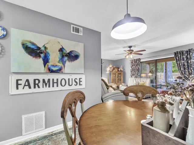 a view of a dining room with furniture wooden floor and chandelier