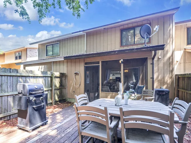 a view of a patio with table and chairs
