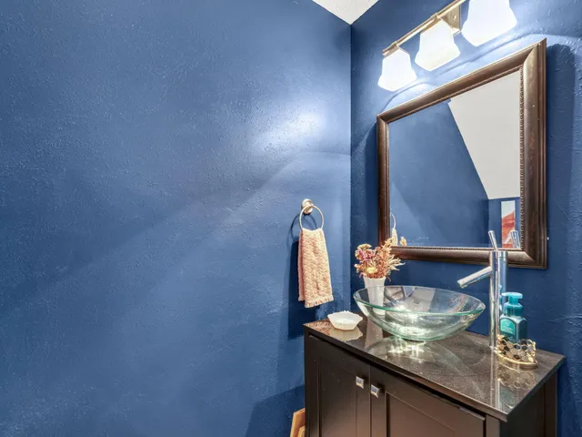 a view of kitchen with sink and mirror