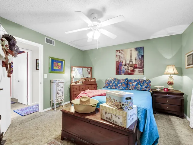 a bedroom with furniture and a chandelier