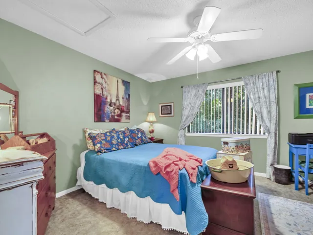 a bedroom with two beds and a window