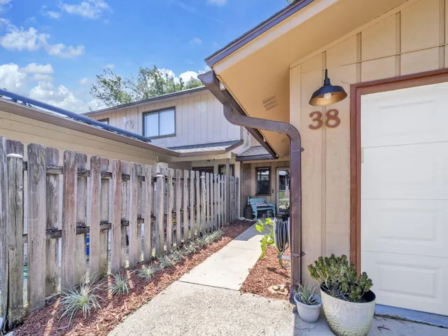 a backyard of a house with outdoor seating