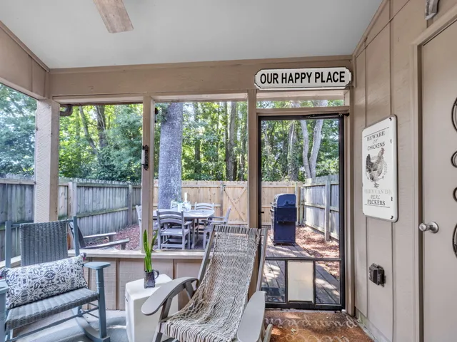 a living room with furniture and large windows