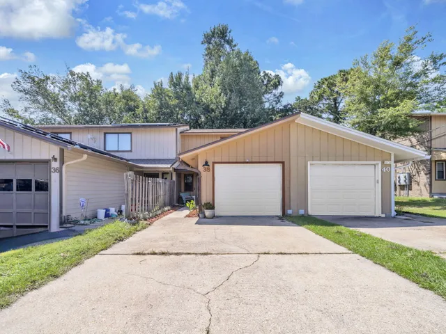 a house with a yard and a large parking space