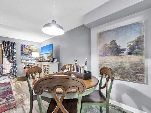 a view of a dining room with furniture and a chandelier