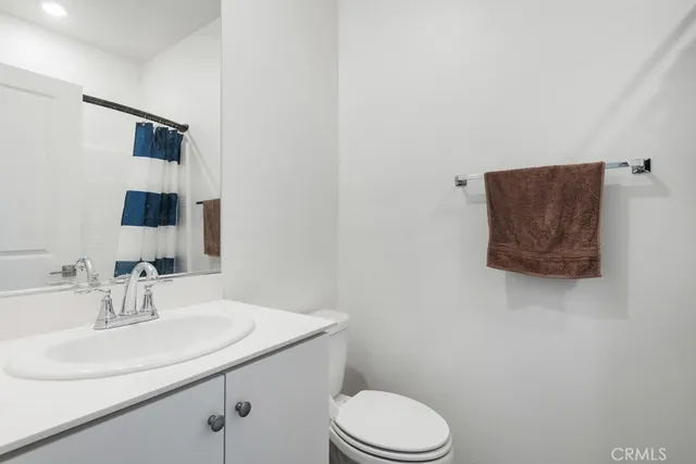 a bathroom with a sink toilet and mirror