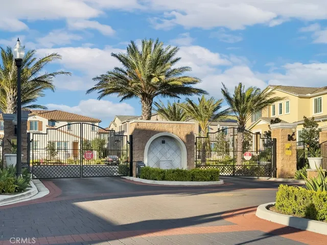 a front view of multiple houses with yard and green space
