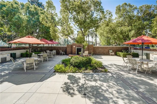 a view of backyard with outdoor seating and trees