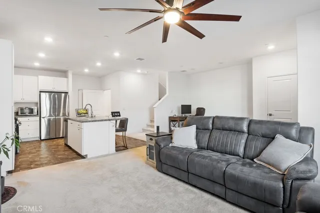 a living room with furniture with kitchen view