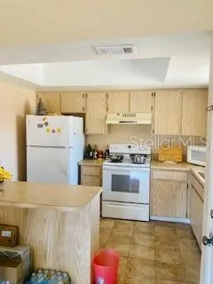 a kitchen with a white cabinets and white appliances