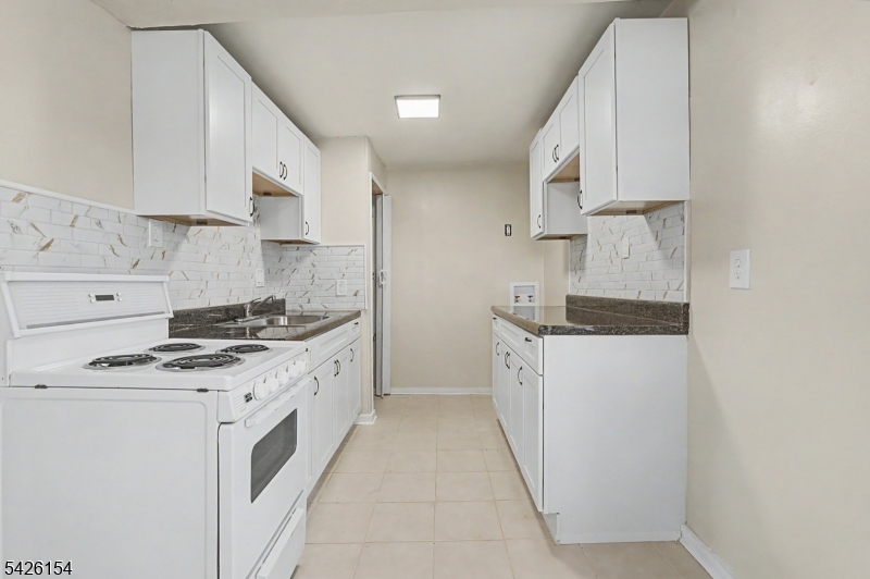 10 Berton Road Boonton, NJ 07005 - Photo 8 of 20 a kitchen with a stove top oven sink and cabinets