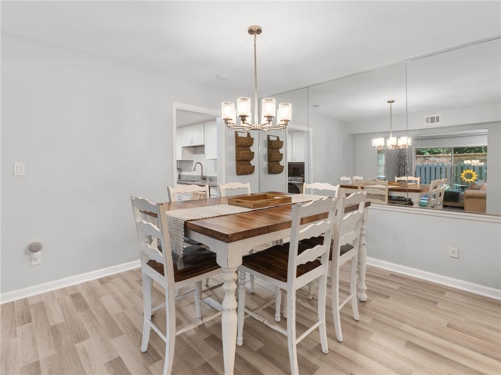 6851 Roswell Road, Unit H26 Atlanta, GA 30328 - Photo 8 of 49 a view of a dining room with furniture and chandelier