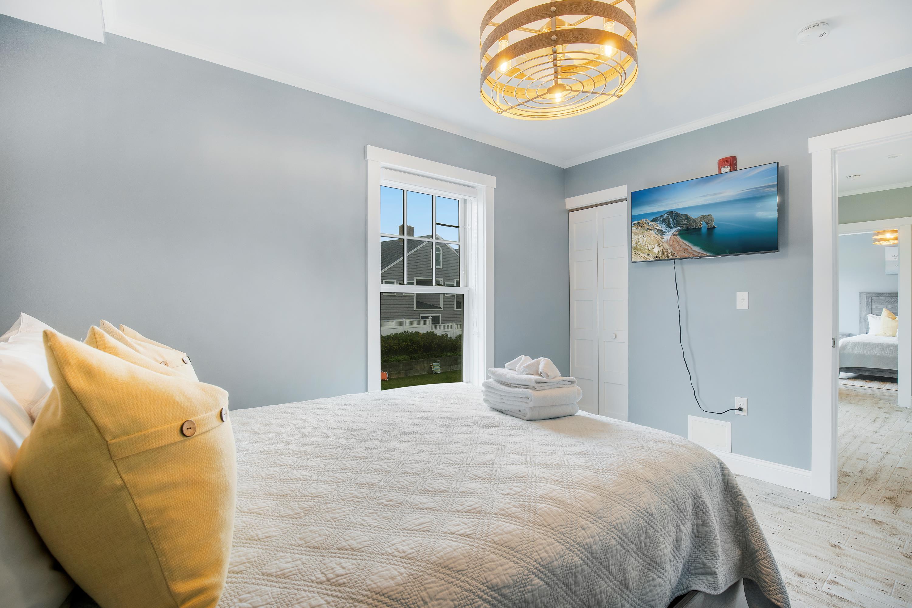 405 Old Wharf Road, Unit B204 Dennis, MA 02639 - Photo 23 of 33 a bedroom with a bed and a window