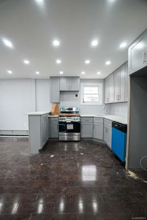 a kitchen with stainless steel appliances a refrigerator sink and microwave