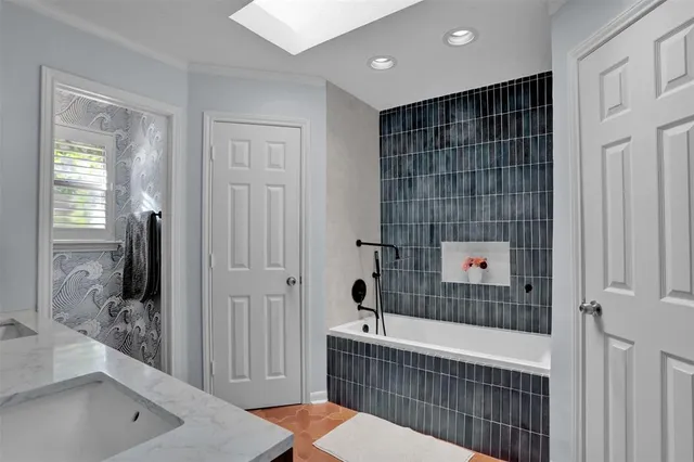a bathroom with a bathtub and shower