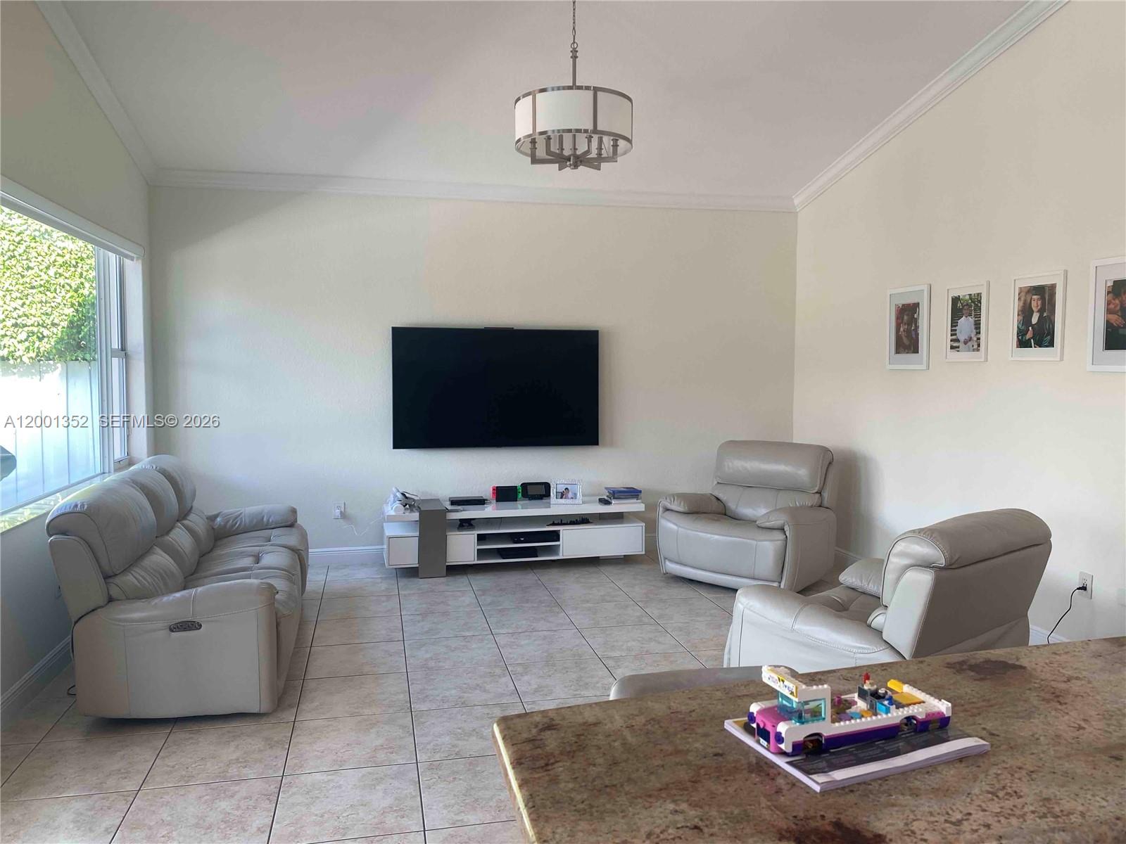 14302 Southwest 15th Street Miami, FL 33184 - Photo 19 of 63 a living room with furniture and a flat screen tv