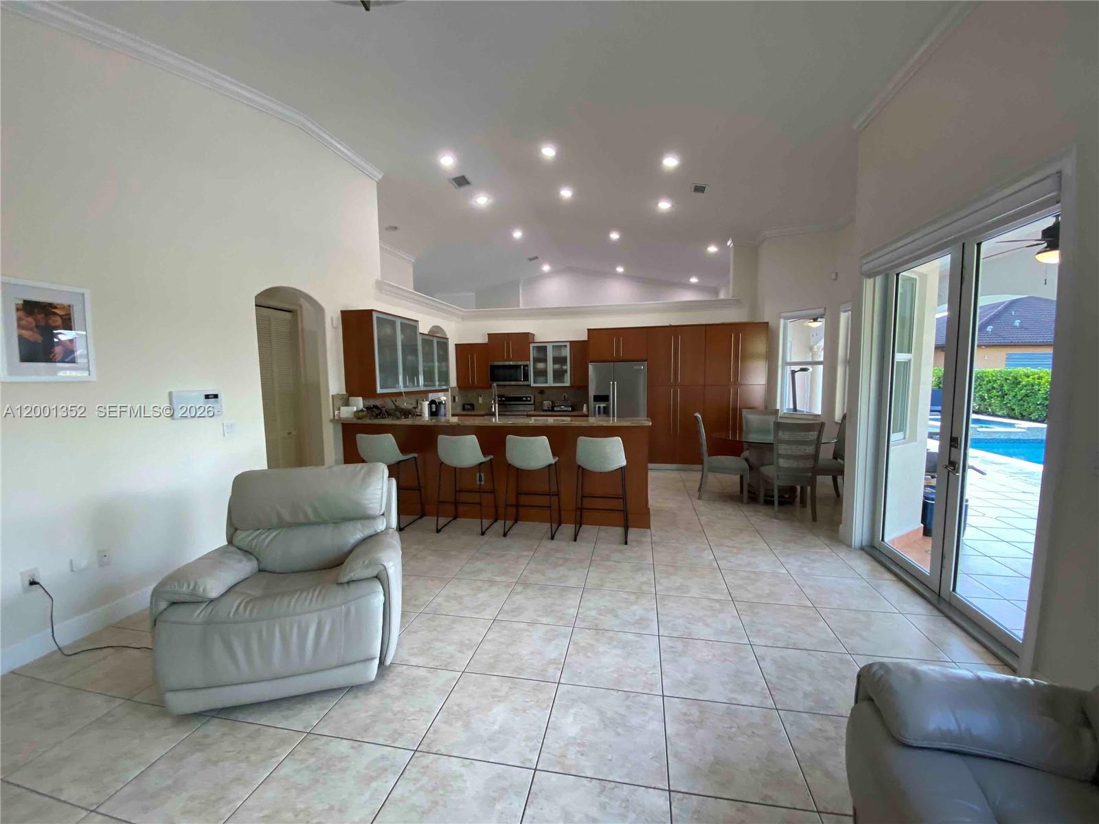 14302 Southwest 15th Street Miami, FL 33184 - Photo 21 of 63 a living room with furniture and a large window